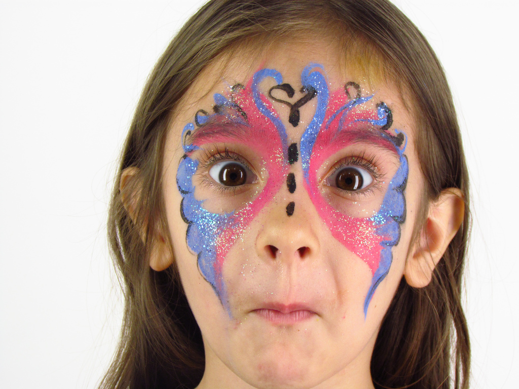 Girl with painted face representing facial expressions